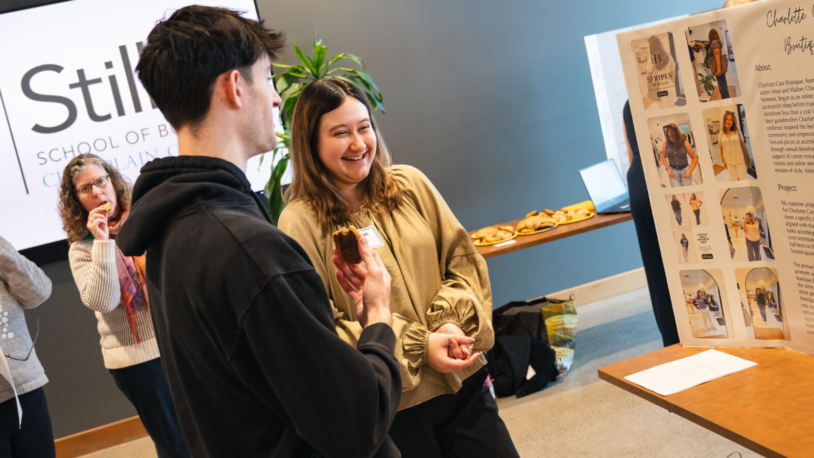 Two students talking during a capstone presentation in Hula