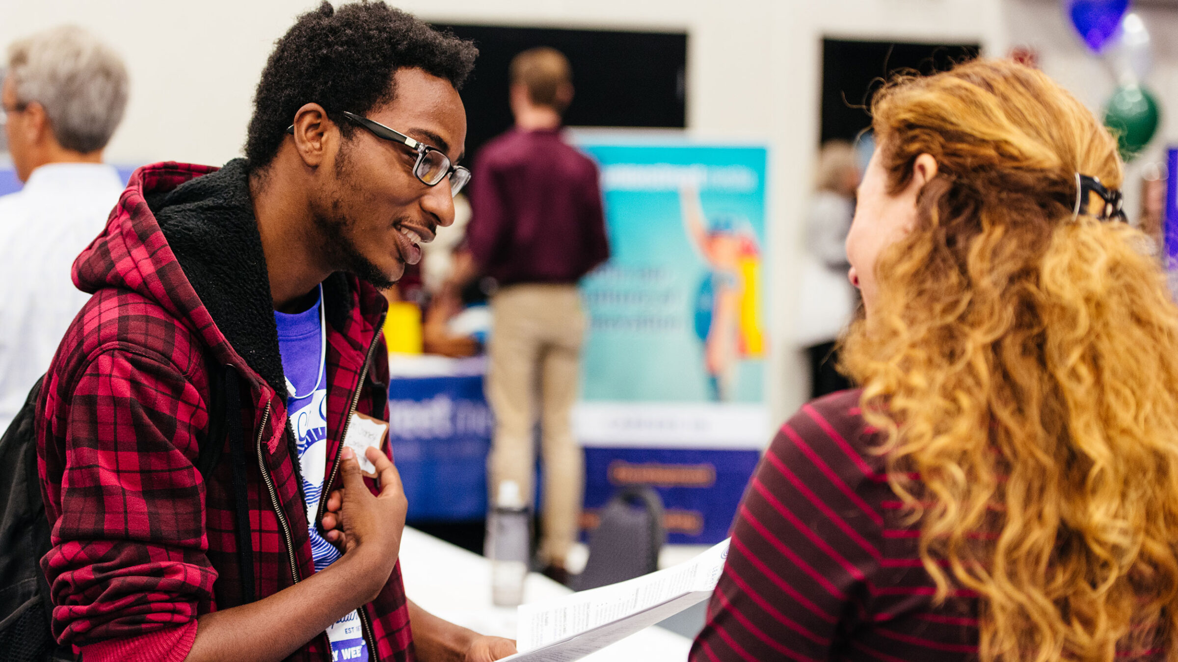 Student talks with an employer at a career fair