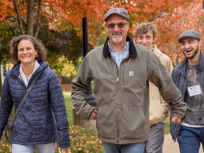 Students and family walking on campus in the fall for Champlain Weekend