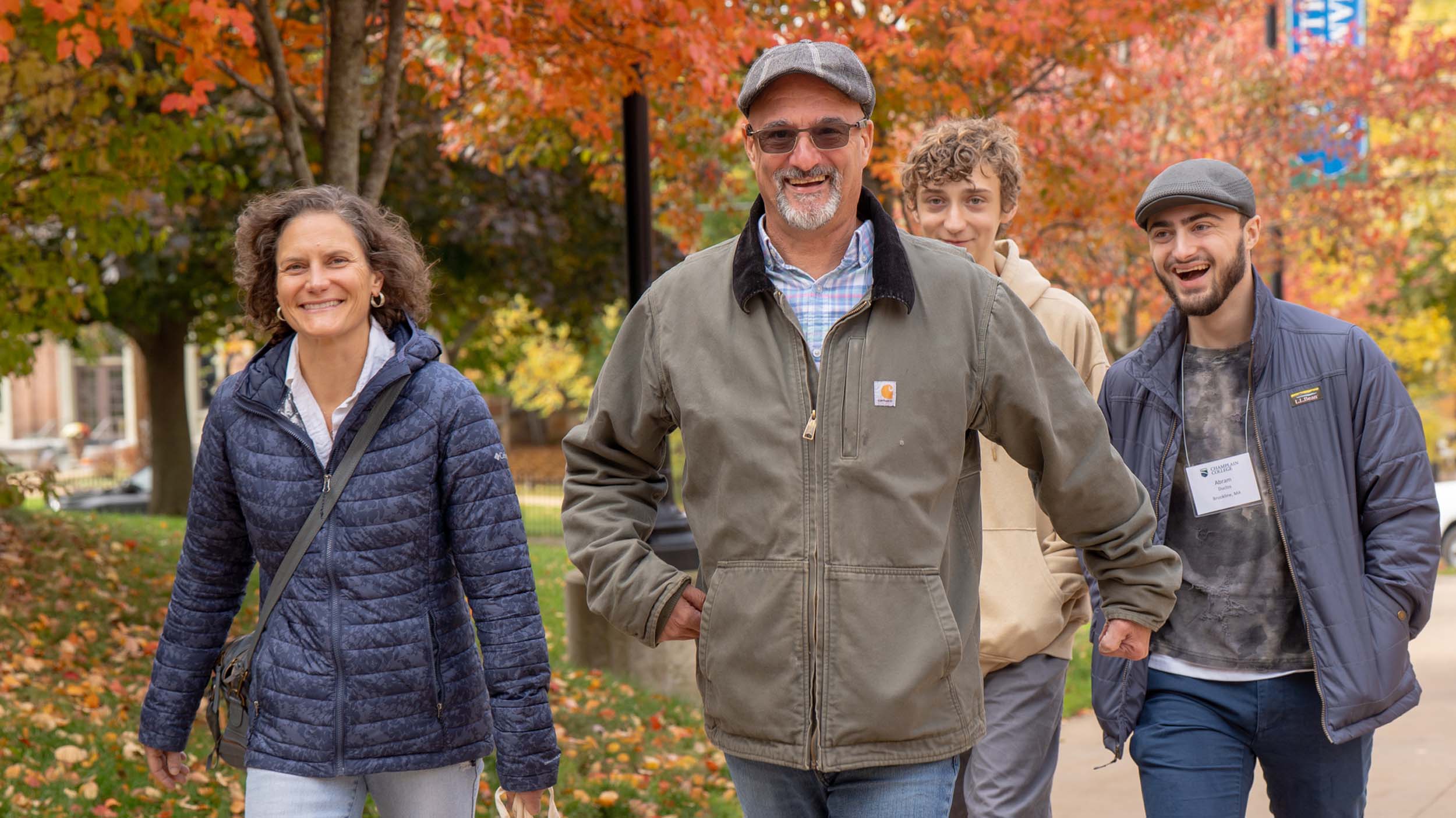 Students and family walking on campus in the fall for Champlain Weekend