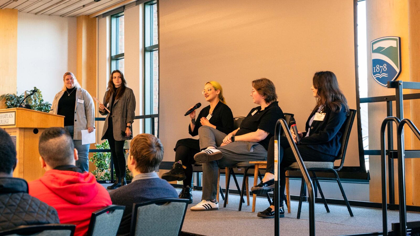 Students and Alumni speaking on a panel in the Champlain room on campus