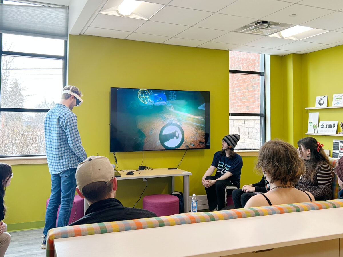 Students demo a virtual reality game in the lab.