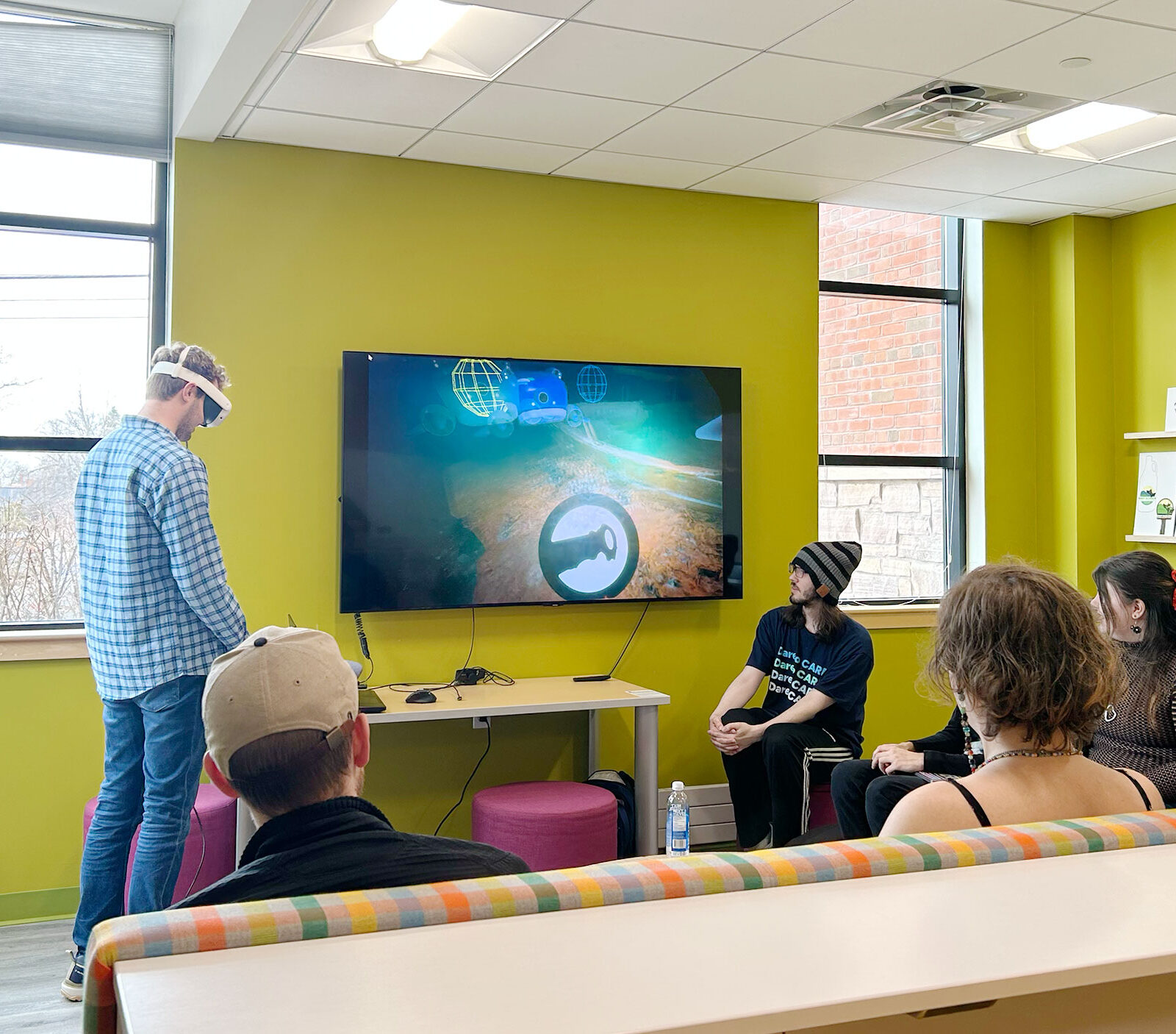 Students demo a virtual reality game in the lab.