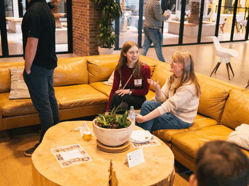 A student networks with an employer at Stiller Women in Business networking event