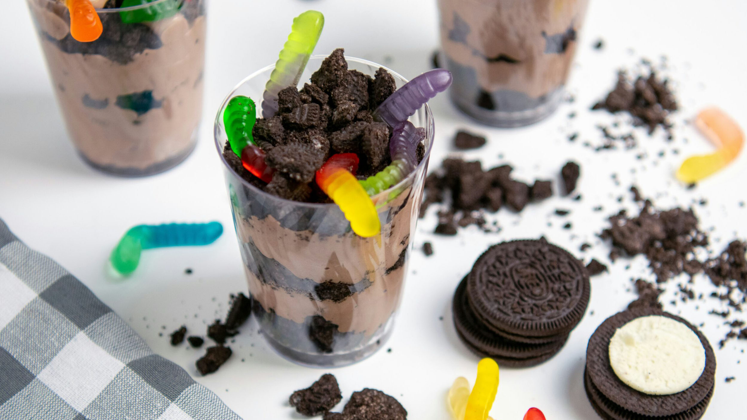 A stock image of a dirt cup with gummy worms
