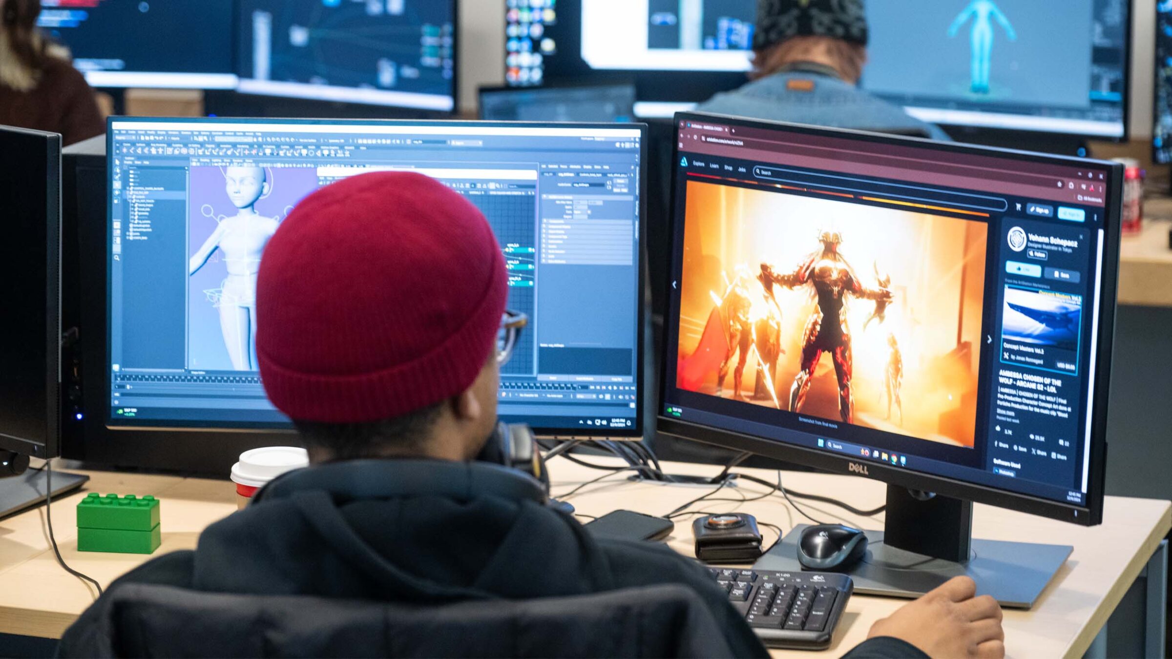 Student working on multiple monitors and building 3D animations using references