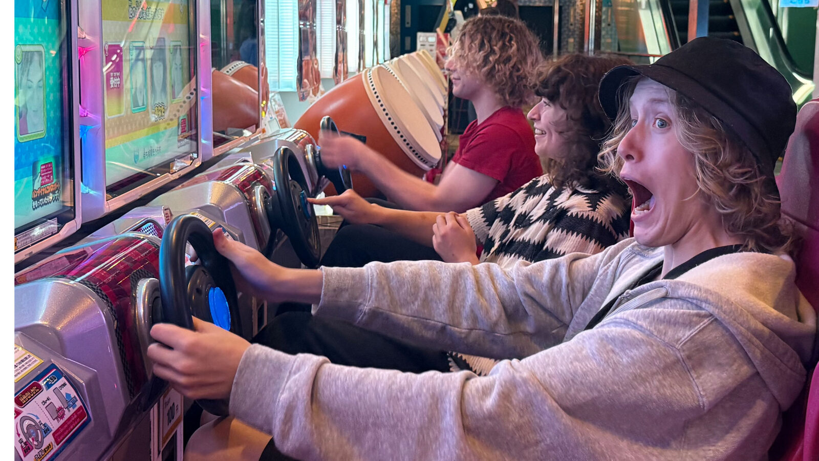 students drive an arcade machine