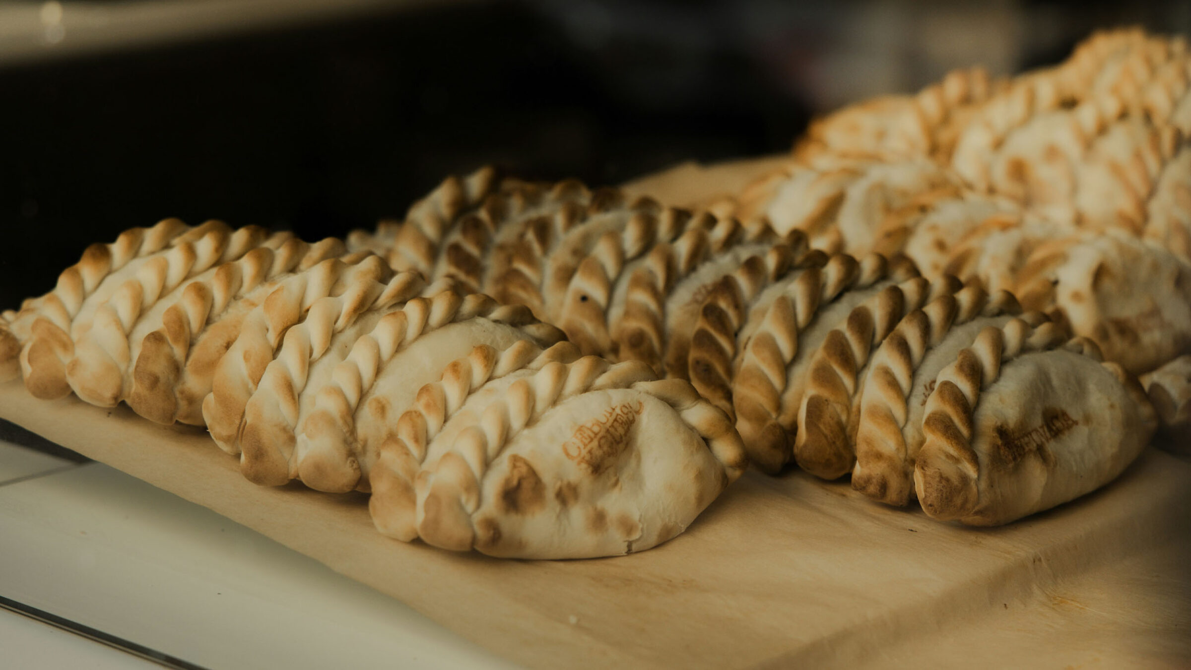 Stock images of empanadas on a cutting board