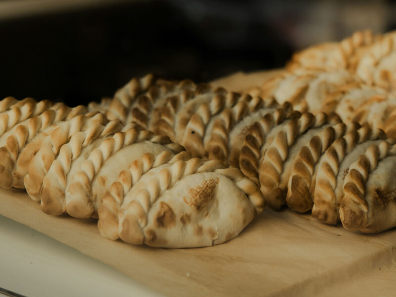 Stock images of empanadas on a cutting board