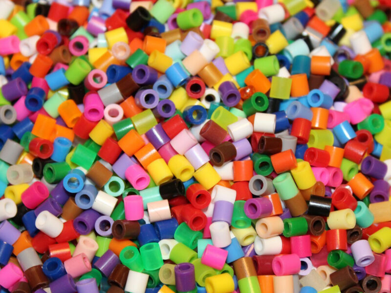 A pile of rainbow-colored pearl beads for crafting