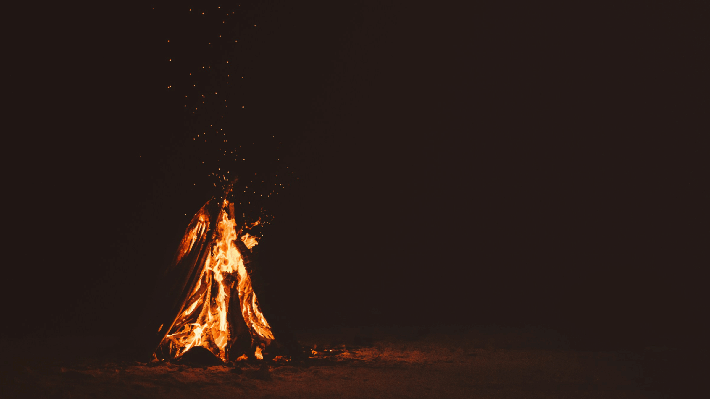 A stock photo of a black background with a campfire.