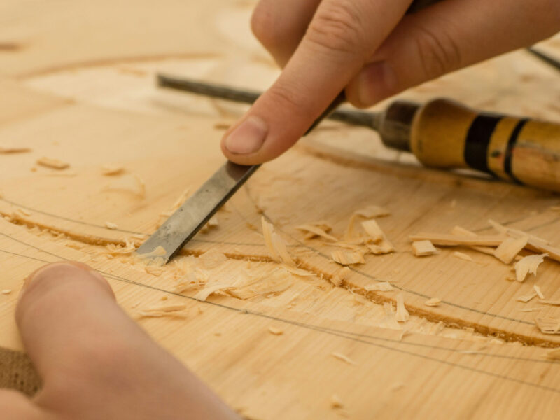 A close up photo of a person carving wood