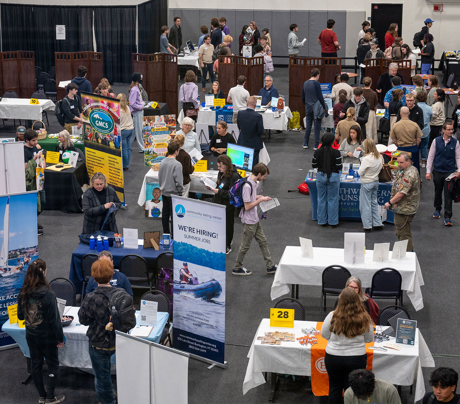 overhead view of a large group of students talking with employers at tables