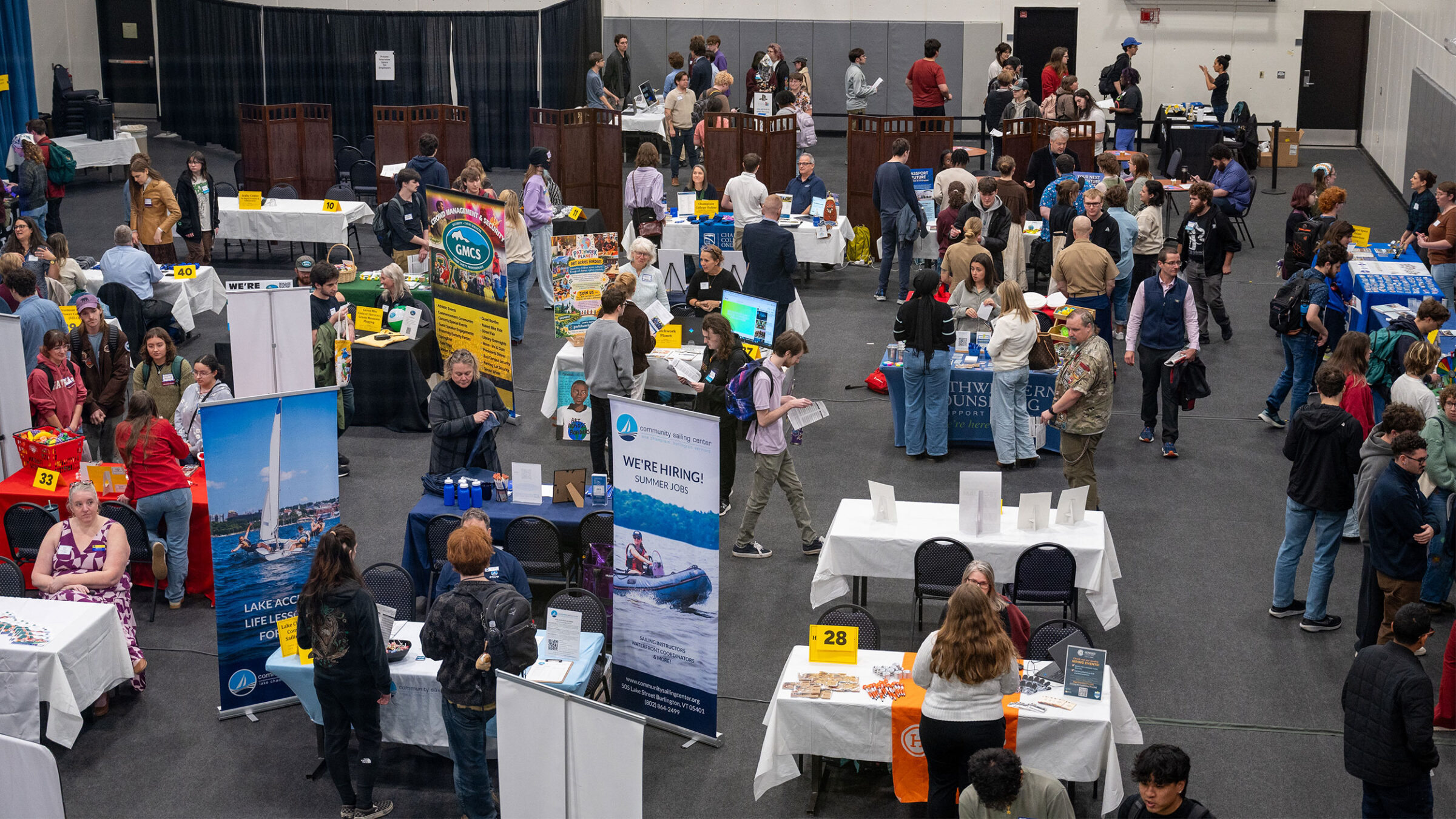overhead view of a large group of students talking with employers at tables