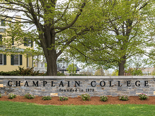 stone wall with Champlain College lettering