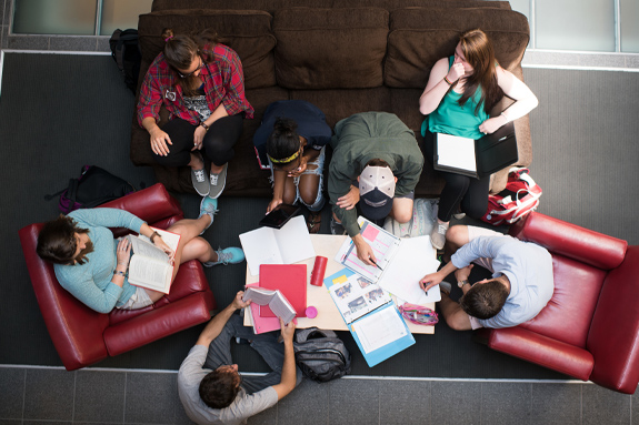 group of students study together in a common area of campus