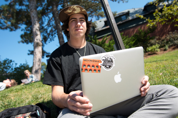 student using laptop while outdoors