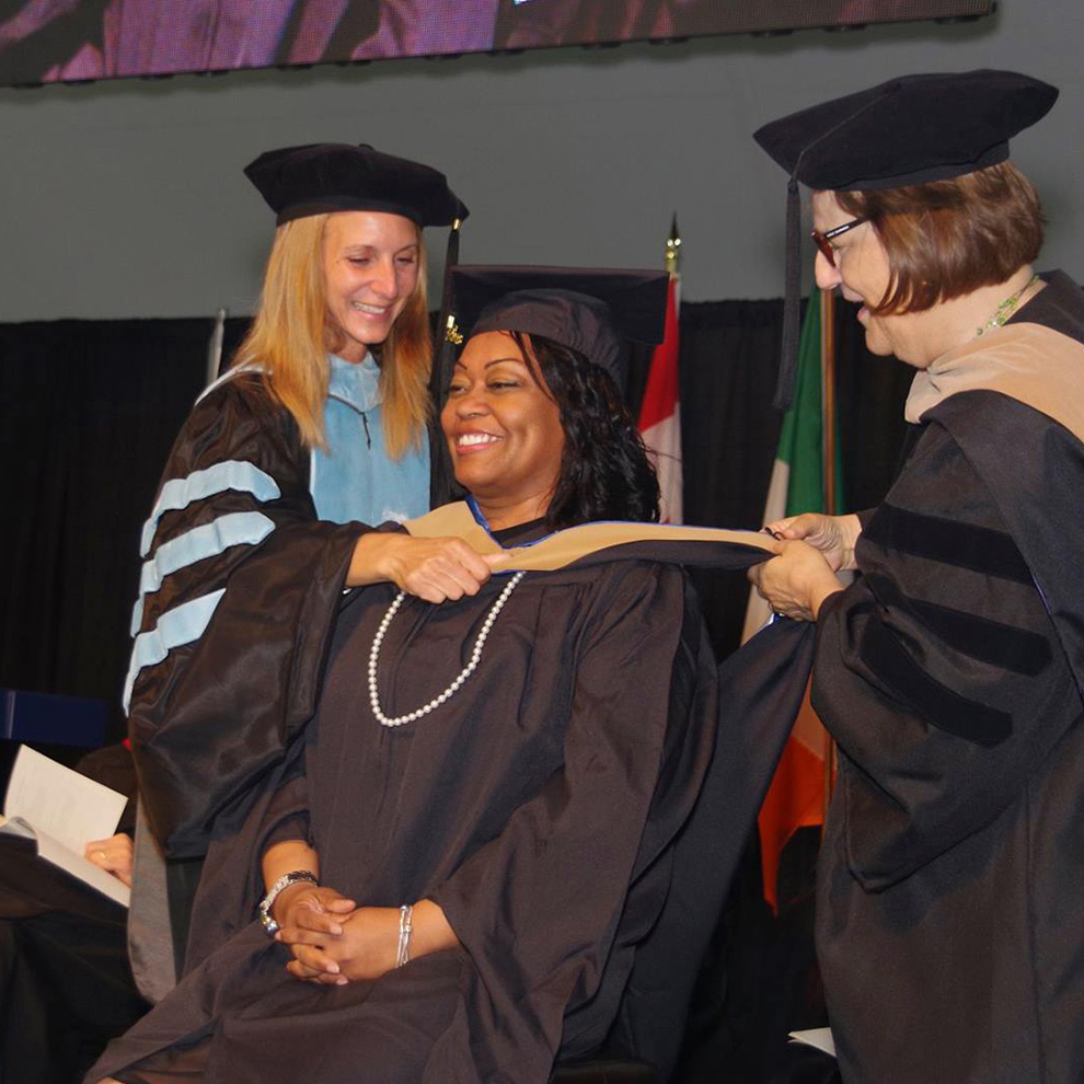 masters graduate getting hooded
