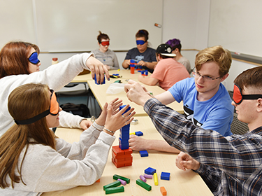 Students working in class on a group building game