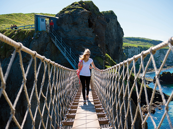 students crosses a rope bridge in Ireland